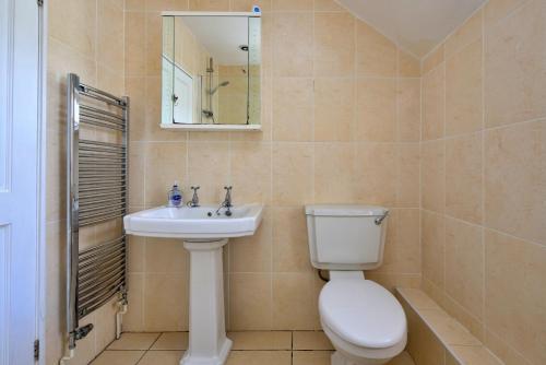 a bathroom with a toilet and a sink at Finest Retreats - Artro View in Llanbedr