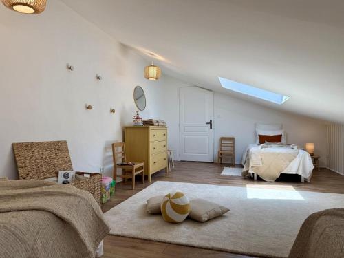 a bedroom with a bed and a dresser and a window at Etxean irria in Hasparren