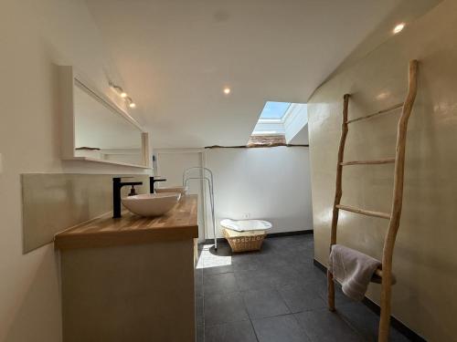 a small bathroom with a sink and a toilet at Etxean irria in Hasparren
