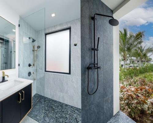 a bathroom with a shower and a sink at Pestica Villa Private Pool in Leeward