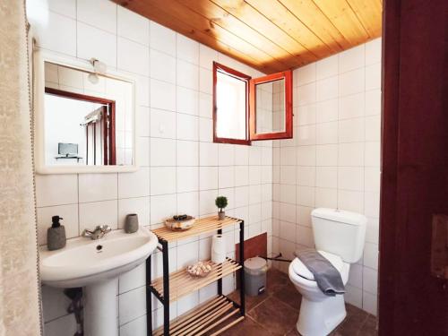 a bathroom with a sink and a toilet at Lerios in Vrachonisída Savoúra