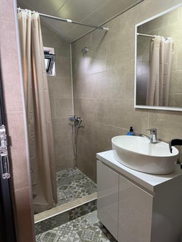 a bathroom with a sink and a shower at Our village in Khoni