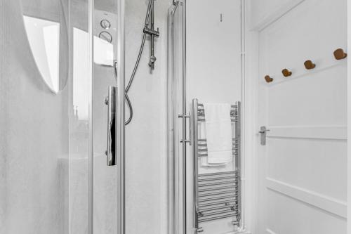a bathroom with a shower with a glass door at Haregate House 3BR Leek Peak District Sleeps 5 in Leek
