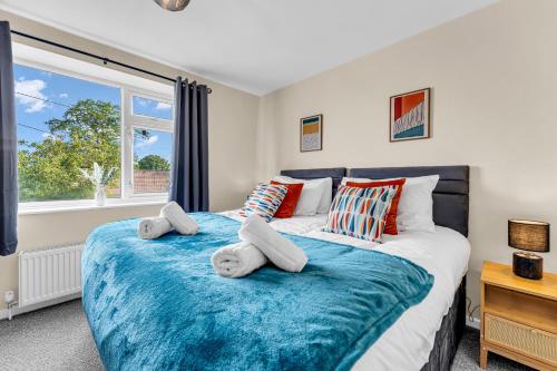 a bedroom with a large bed with pillows and a window at Haregate House 3BR Leek Peak District Sleeps 5 in Leek