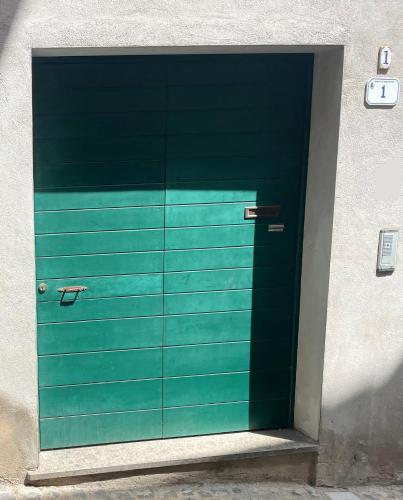 a green garage door in a building at Borgo nel Centro in Ronciglione