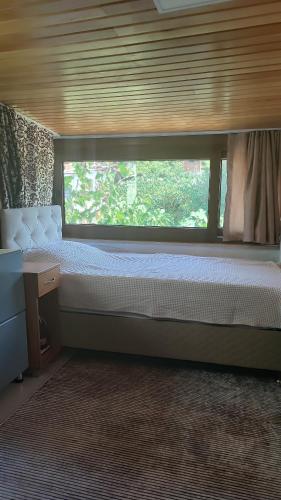 a bedroom with two beds and a window at Demir Apart Otel in Kaş