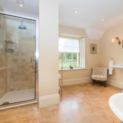 a bathroom with a shower and a sink at Week Farm Manor in Wellow
