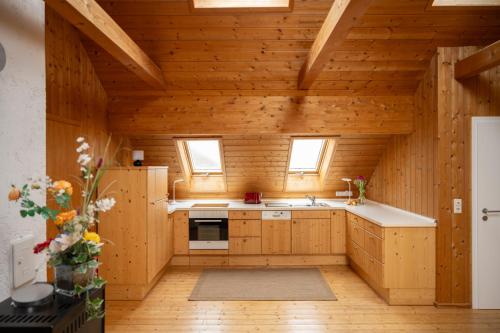 a kitchen with wooden walls and a wooden ceiling at Michlhof in Oberostendorf