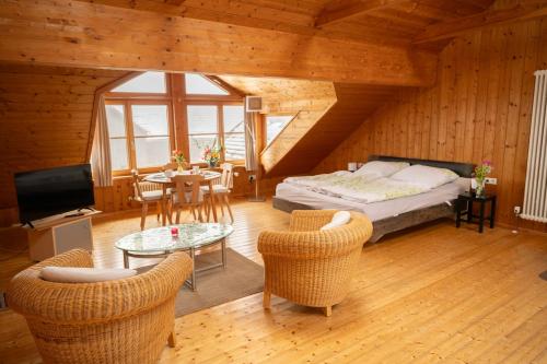 a bedroom with a bed and a table and chairs at Michlhof in Oberostendorf