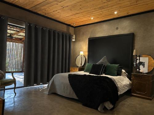 a bedroom with a large bed with green pillows at FollyFoot Manor in Midrand