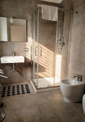 a bathroom with a shower and a tub and a sink at Il Mulino in Locri