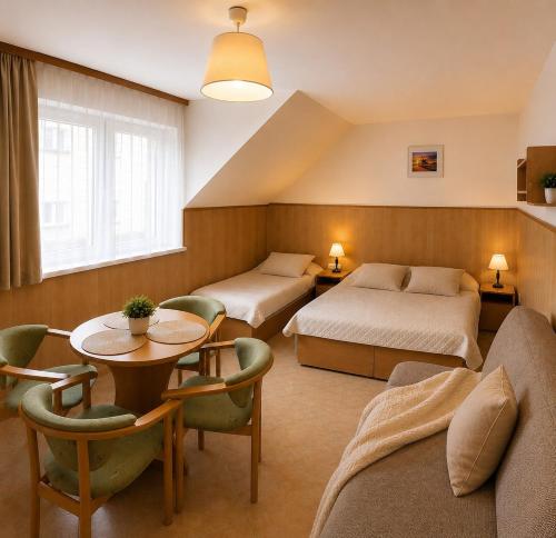 a hotel room with two beds and a table at DW Viva in Rewal