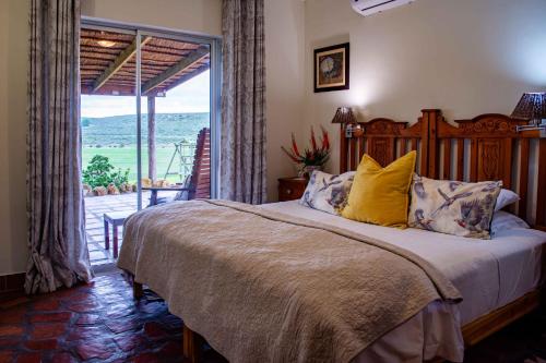 a bedroom with a bed and a sliding glass door at Skeiding Guest Farm in Heidelberg