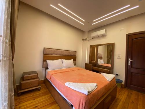a bedroom with a bed and a large mirror at Luxury Apartments - Downtown Cairo in Cairo