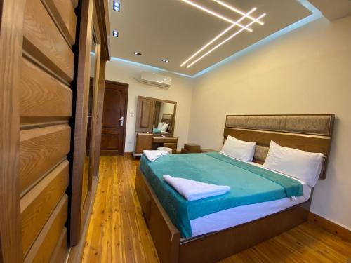 a bedroom with a bed with a blue bedspread at Luxury Apartments - Downtown Cairo in Cairo