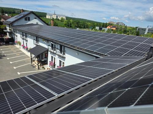 a group of solar panels on the roof of a building at Pensiunea Vila Chesa in Corunca