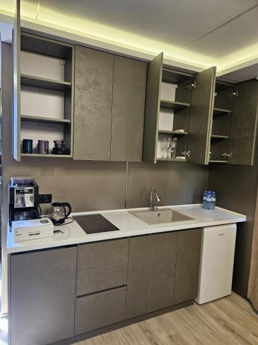 a kitchen with stainless steel cabinets and a sink at Econest Aparan in Aparan