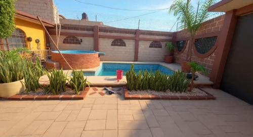 a backyard with a swimming pool and a house at Mayumi weekend accommodation in Cocoyoc