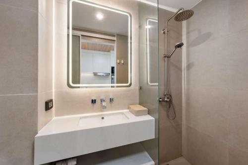a bathroom with a sink and a mirror at Modern Studio at Wing Samui in Bophut