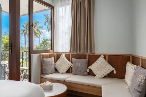 a living room with a couch and a window at Modern Studio at Wing Samui in Bophut
