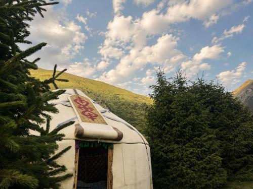 a rv with a sign on the top of it at Forest Yurt House Altyn Arashan in Mineralʼnyy Istochnik Altyn-Arasan
