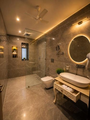 a bathroom with a sink toilet and a shower at Jawai Garh Resort in Bīsalpur