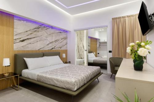 a bedroom with a bed and a table with a vase of flowers at La Rocca D’Amuri in Partinico