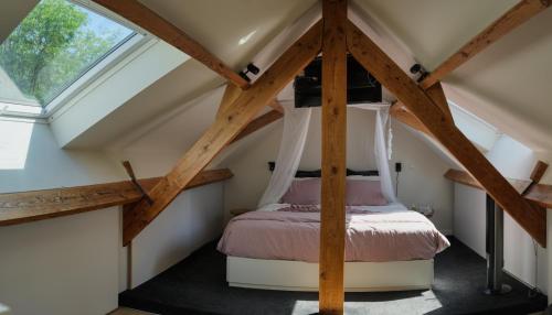 a bedroom with a bed in a attic at TML Music Guesthouse in Aartselaar