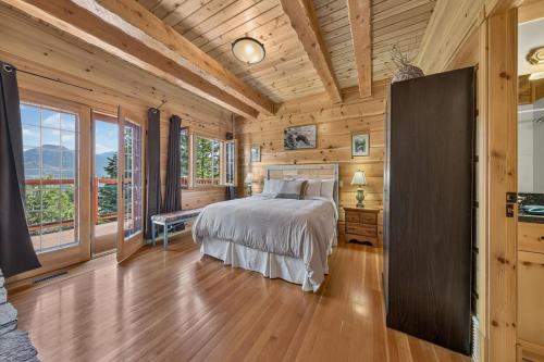 a bedroom with a bed and a wooden ceiling at Mountain View Log Home in Invermere in Invermere