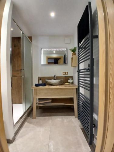 a bathroom with a sink and a mirror at Le Rucher de St Pierre in Sainte-Marie-aux-Mines