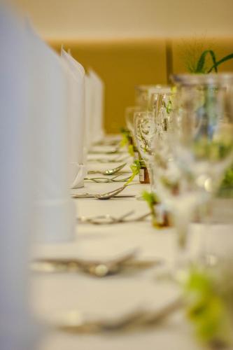 a row of glasses sitting on a table at Hotel & Restaurant Schaumburger Ritter, Rinteln in Rinteln