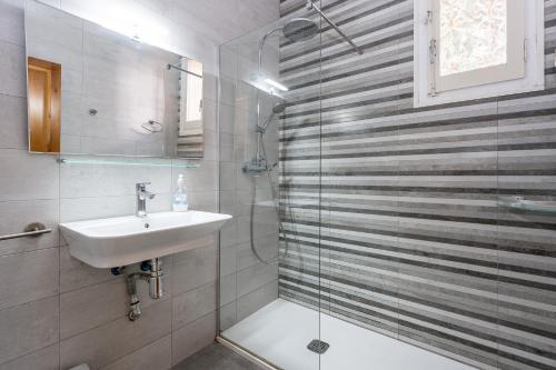 a bathroom with a sink and a shower at Villa 30 m from the beach Cambrils in Cambrils