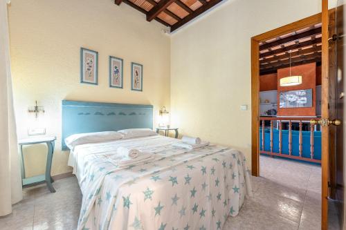 a bedroom with a bed with a blue head board at Villa 30 m from the beach Cambrils in Cambrils