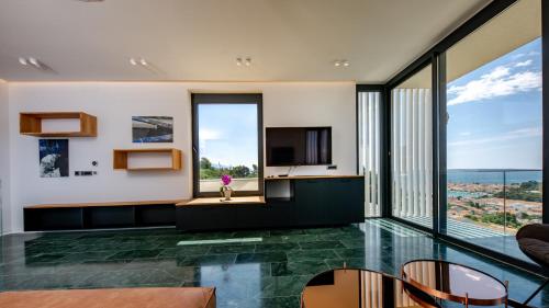 a living room with a view of the ocean at Luxury villa Mar with infinity pool in Rab in Palit