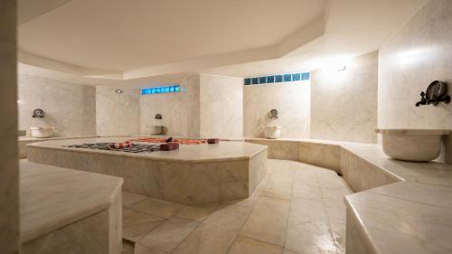 a large kitchen with a stove in the middle at Begonville Hotel in Marmaris