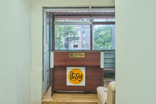 a reception desk in a room with a window at Itsy Hotels Aditya in Nagpur
