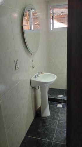 a bathroom with a sink and a mirror at Valdez Resi in Santa Rosa