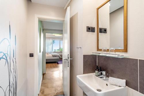 a bathroom with a sink and a mirror at Baden-Chalet - Wandergenuss in Bühl
