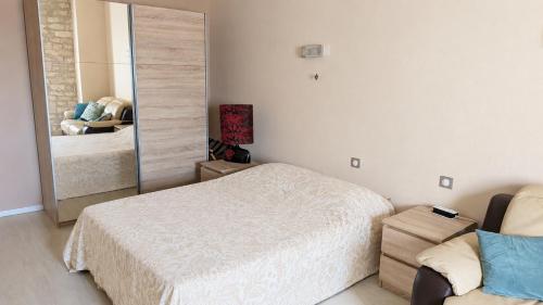 a bedroom with a bed and a mirror at Grande chambre avec piscine in Villeneuve-sur-Vère
