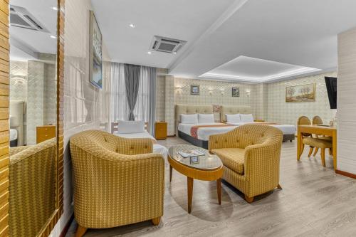a hotel room with a bed and chairs at Suwara Hotel Kepong KL in Kuala Lumpur