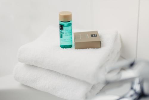 a pile of towels and a bottle of toothpaste at Best Western Malmo Arena Hotel in Malmö