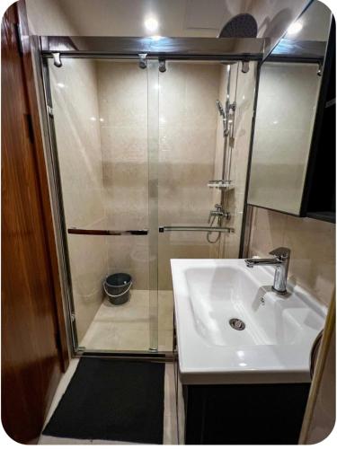 a small bathroom with a sink and a shower at Megatower 4 Diorite Unit in Baguio
