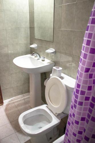 a bathroom with a toilet and a sink at Cabañas Nazareth in Villa Carlos Paz