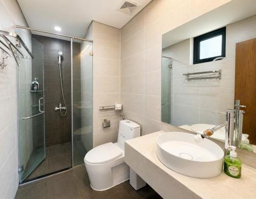 a bathroom with a toilet and a sink and a shower at 2-3 bedroom at HUD building Nha Trang in Nha Trang