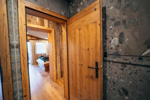 a wooden door in a room with a bedroom at Alpin Chic by Alpe Chalets in Unterseefeld