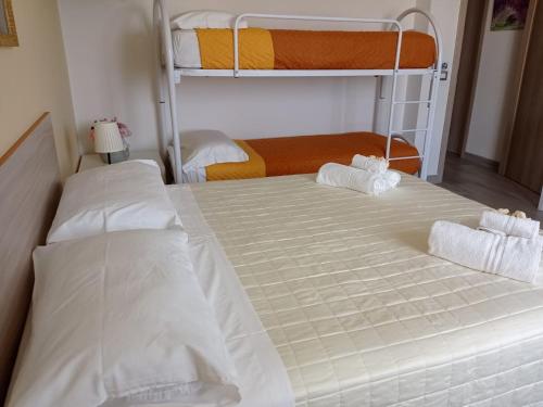 two beds in a room with two bunk beds at B&B Villa Rosa new in SantʼAntonio Abate