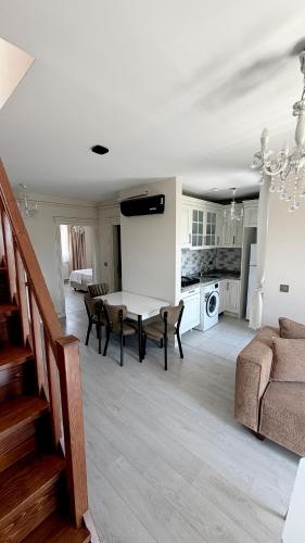 a living room with a table and a couch at Galfa House in Bostancı