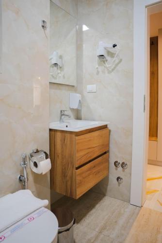 a bathroom with a sink and a toilet at Hotel Ricardo Residence in Ulcinj
