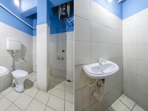 a bathroom with a sink and a toilet at Hotel Swarna Mayuri in Guntūr