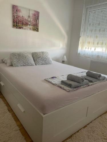 a white bed with two towels on top of it at Sophia in Vranje